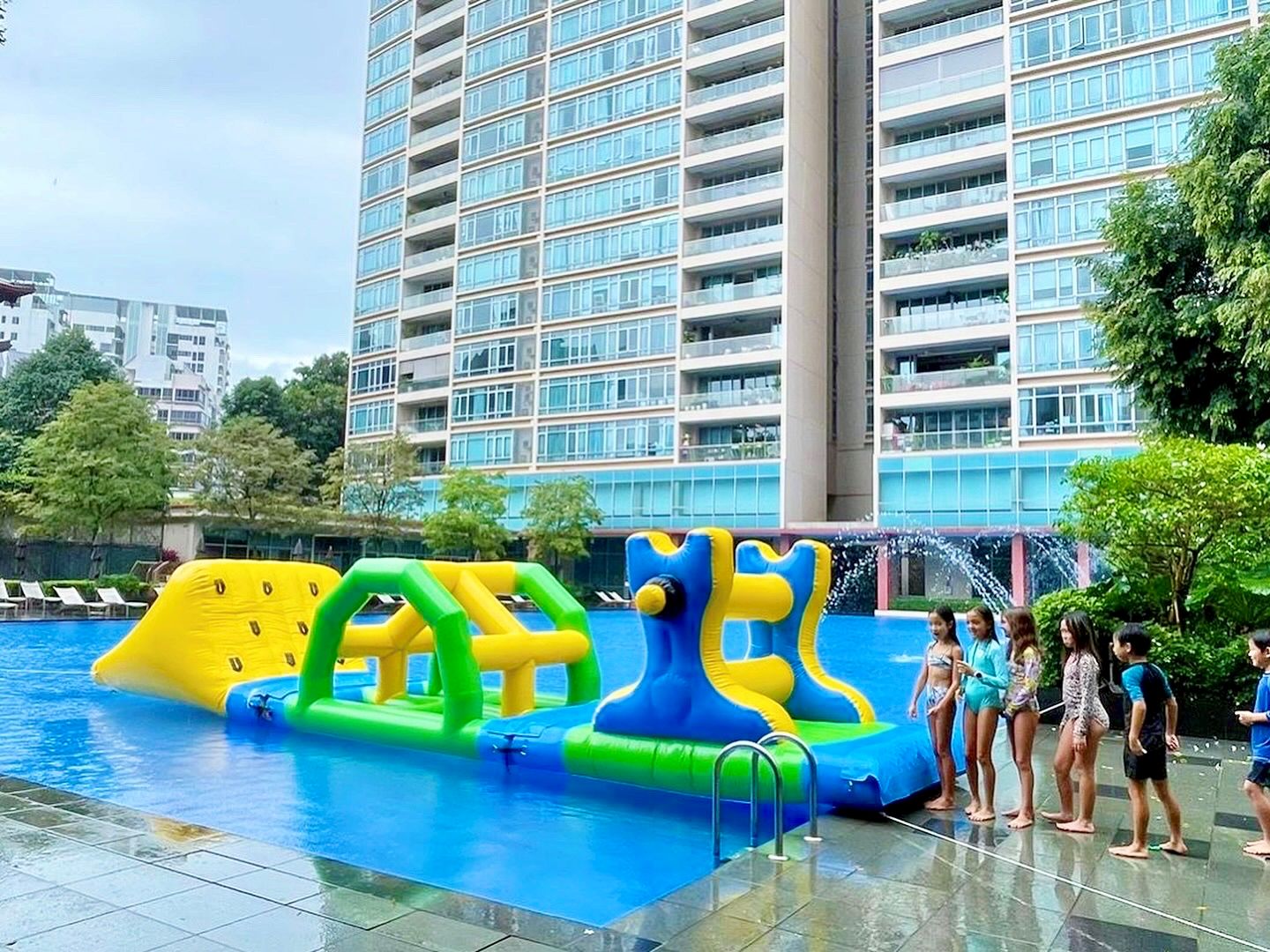 Swimming Pool With Inflatable Obstacle Course And Children 1