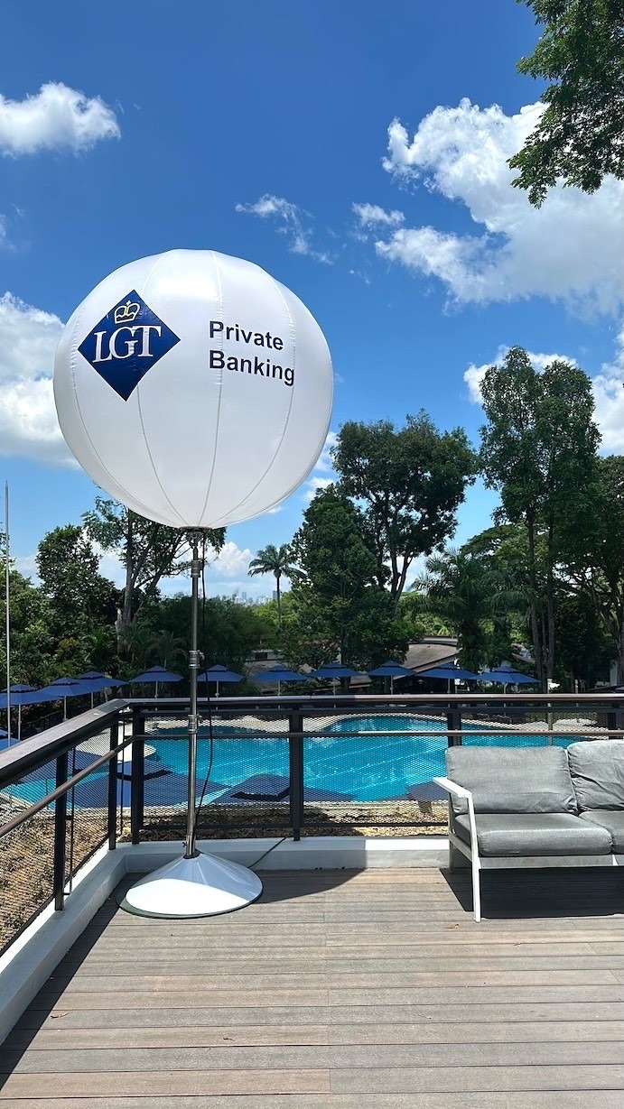 Branded advertising balloon on stand at a corporate poolside event in Singapore