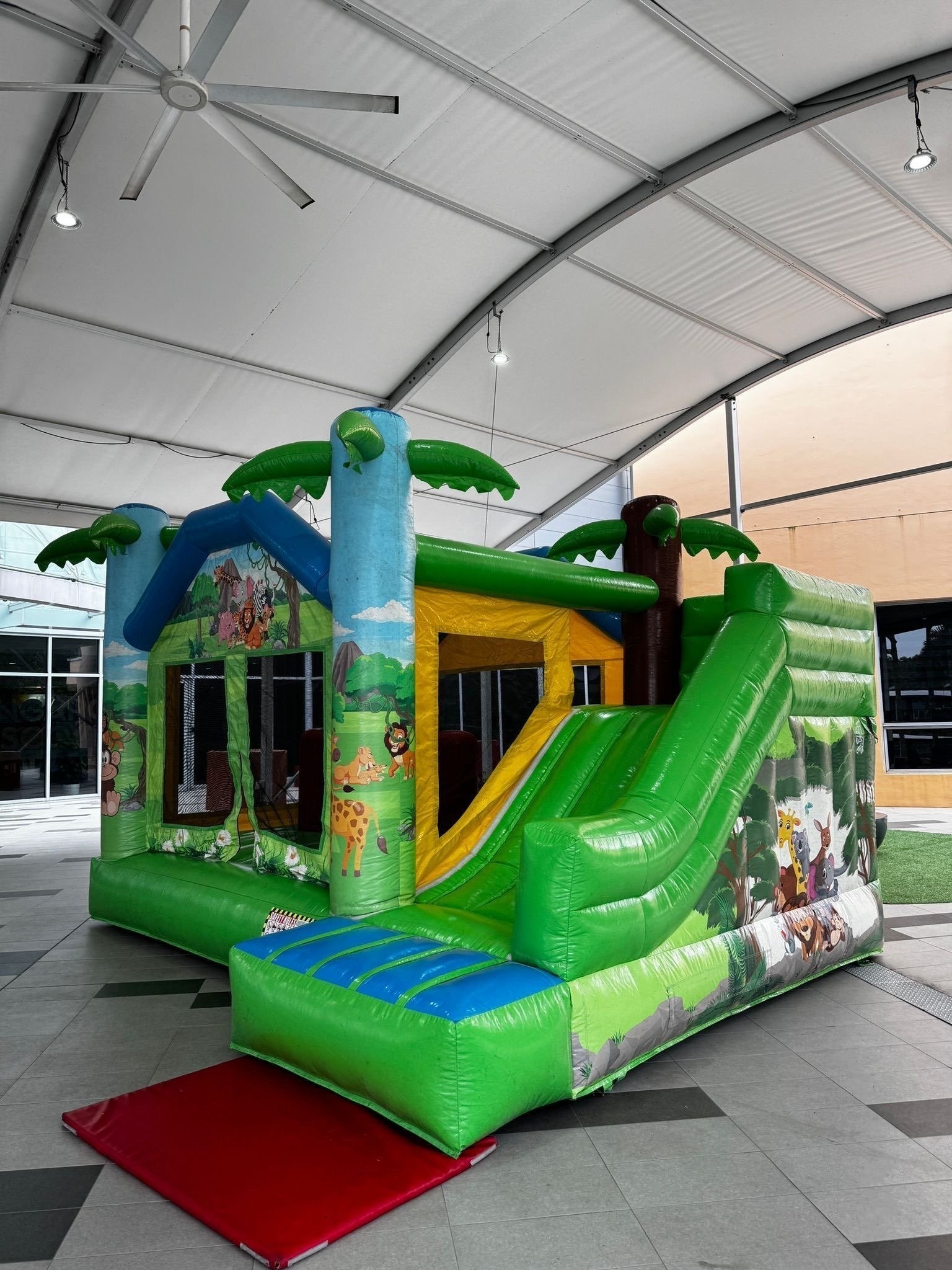 Jungle-themed bouncy castle with slide rental Singapore