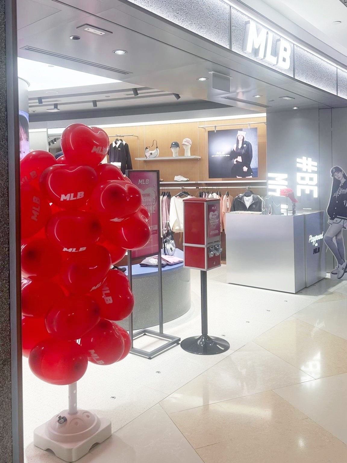 Red heart branded balloon stand for retail store display in Singapore