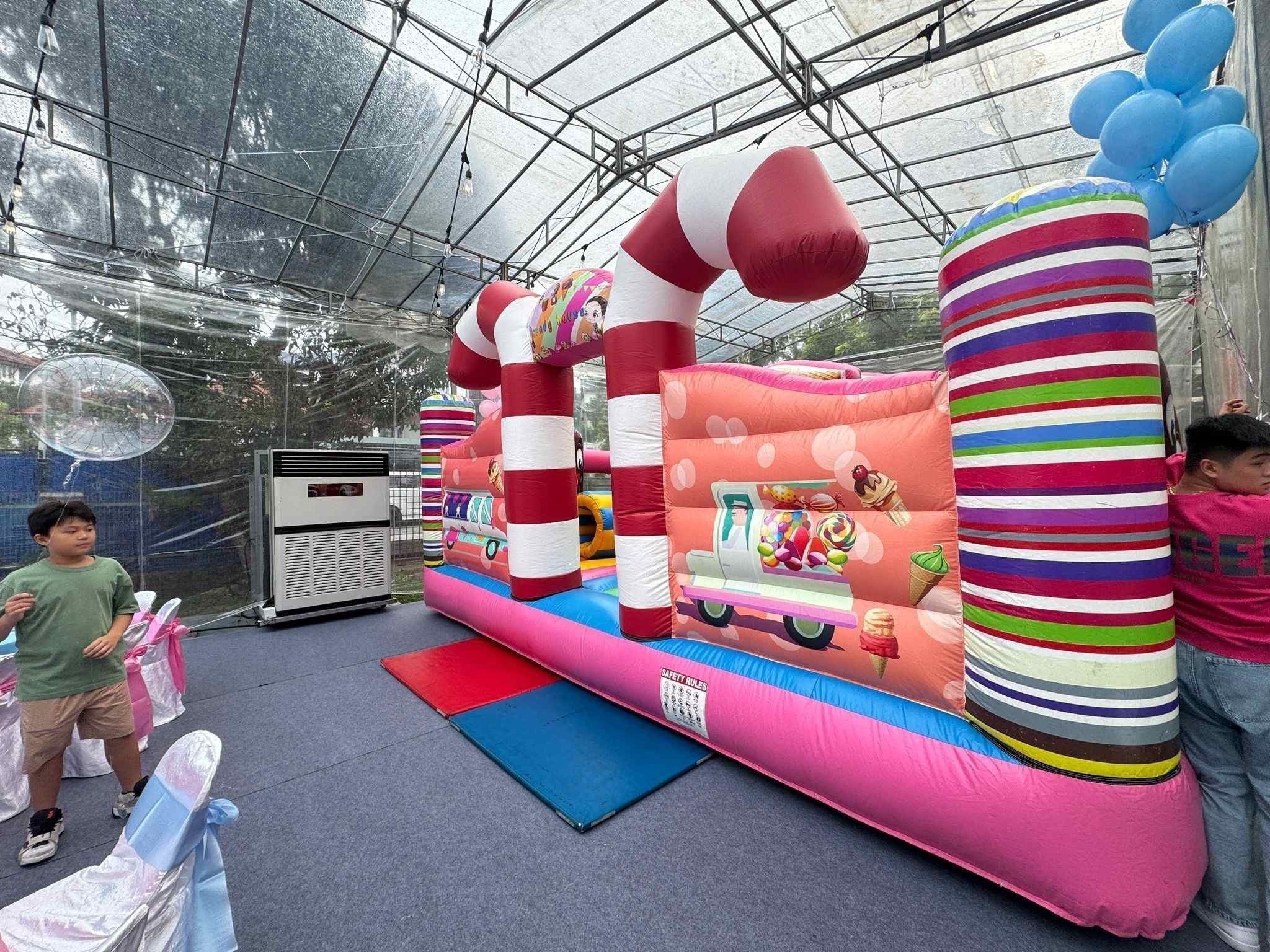 Candy-themed bouncy castle rental at a kids birthday party in Singapore