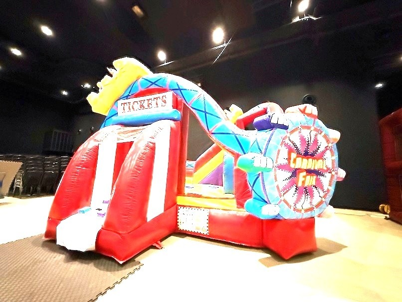 Carnival-themed bouncy castle with slide for indoor event rental in Singapore