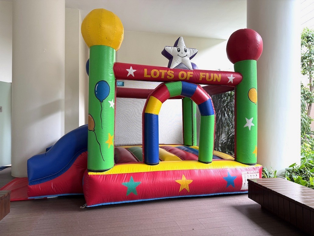 Colorful bouncy castle with slide for kids party rental in Singapore