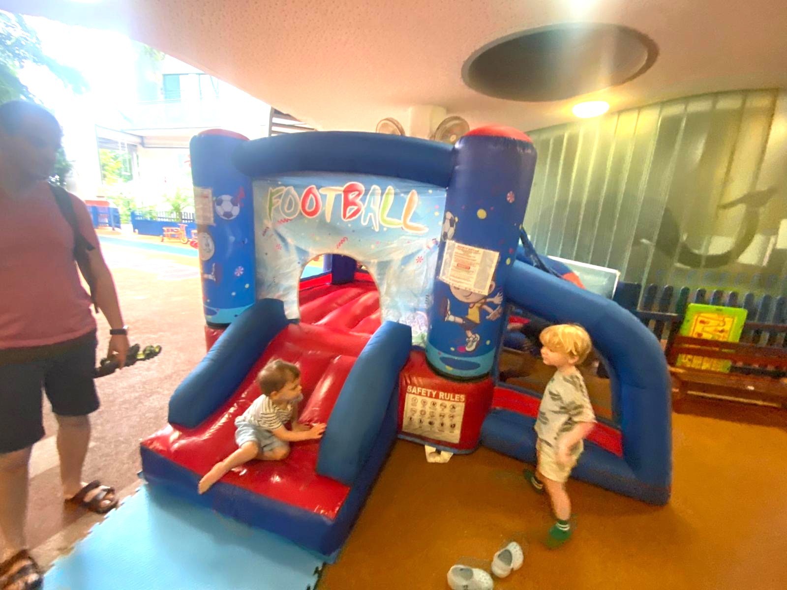 Football-themed bouncy castle Singapore with slide for kids party rental