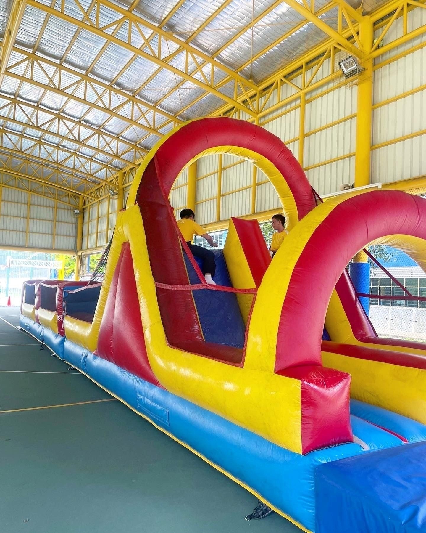 Inflatable obstacle course rental inside an indoor sports hall in Singapore