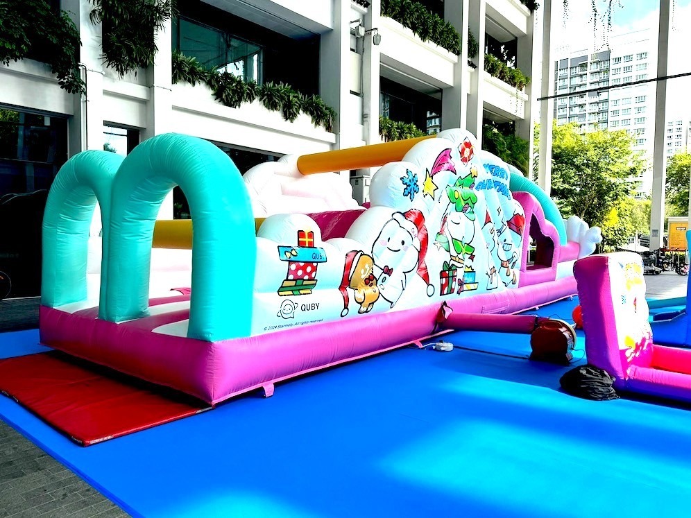 Quby-themed inflatable obstacle course at an outdoor event in Singapore