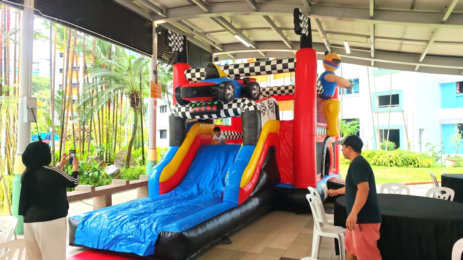 Racing-themed bouncy castle with slide rental for kids party in Singapore