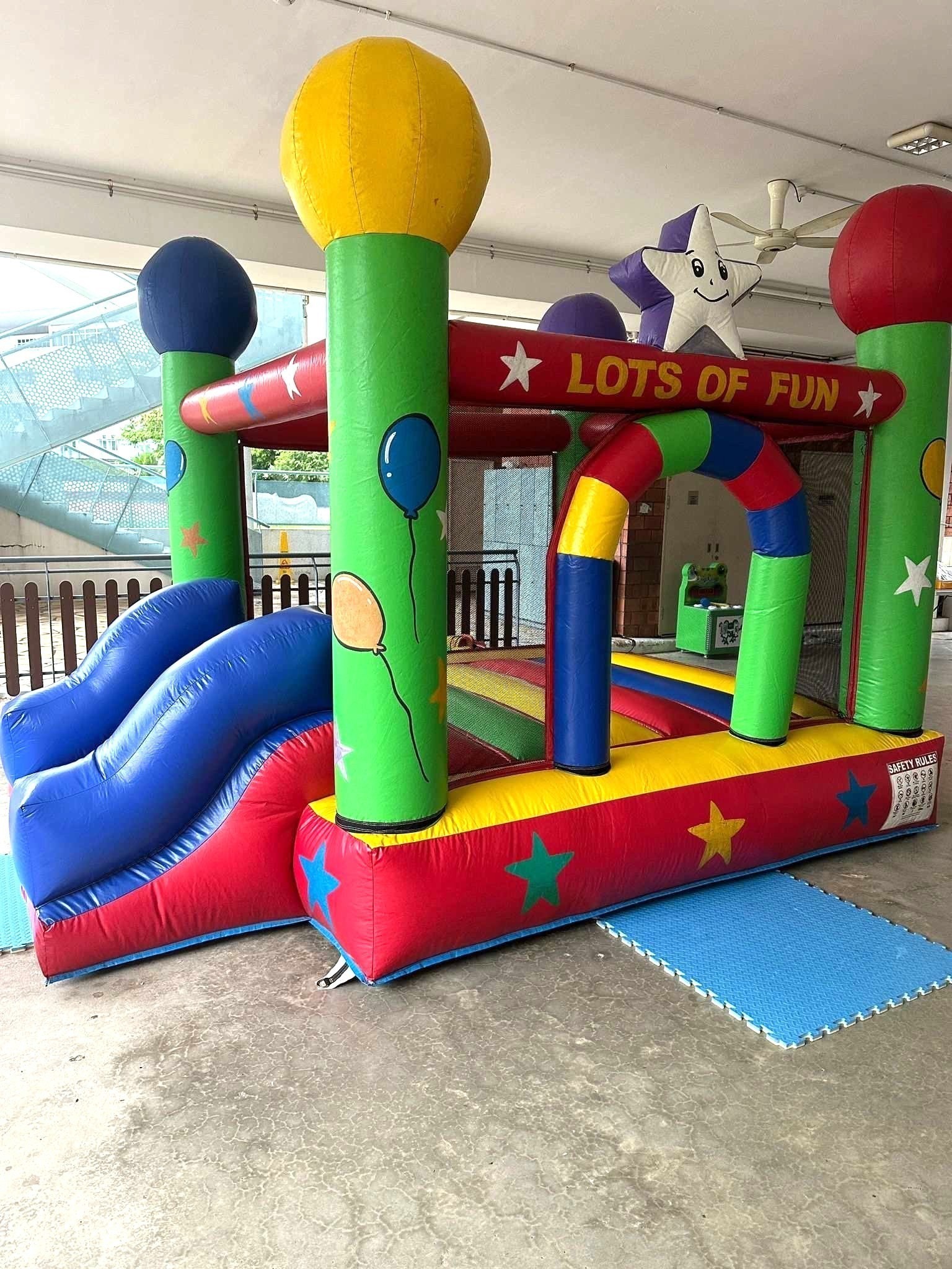 Colorful bouncy castle with slide for kids party rental in Singapore