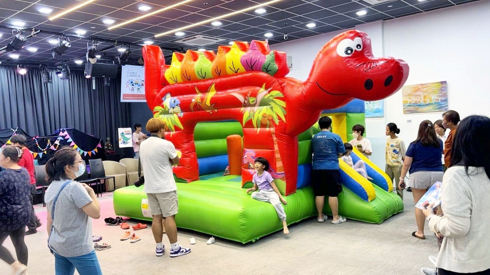 Dinosaur themed bouncy castle rental at an indoor family carnival in Singapore
