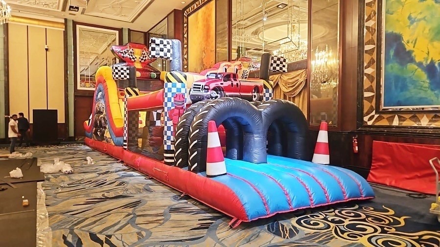 Racing themed inflatable obstacle course bouncy castle at a hotel event in Singapore