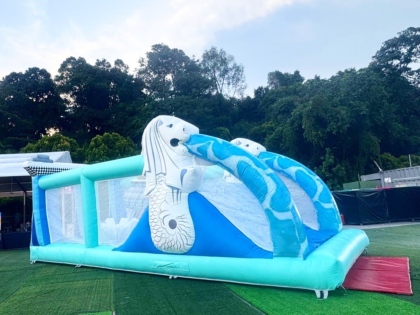 Merlion inflatable bouncy castle slide at an outdoor event in Singapore