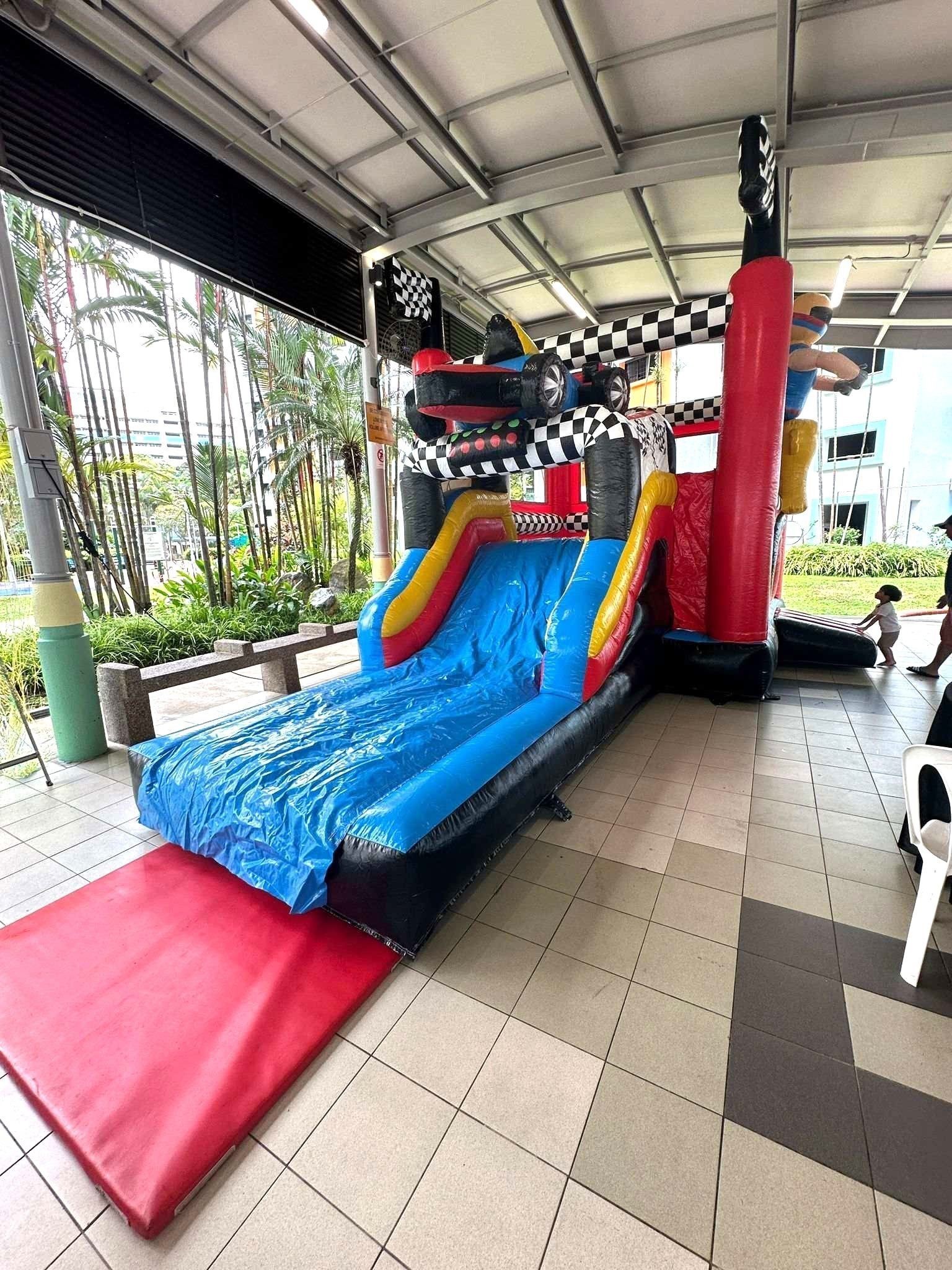 Racing themed bouncy castle slide rental at a kids party in Singapore