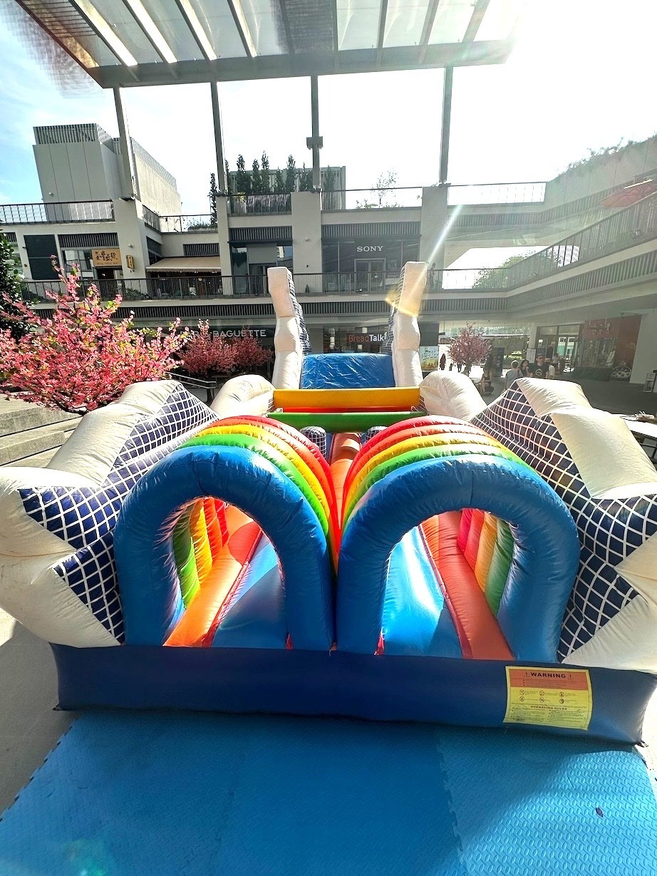 Rainbow inflatable obstacle course rental at an outdoor mall event Singapore