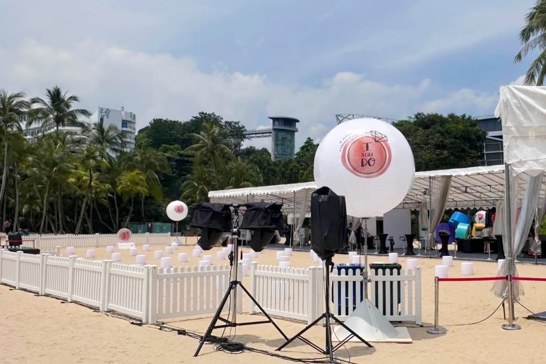 Branded advertising balloon setup at beach corporate event in Singapore