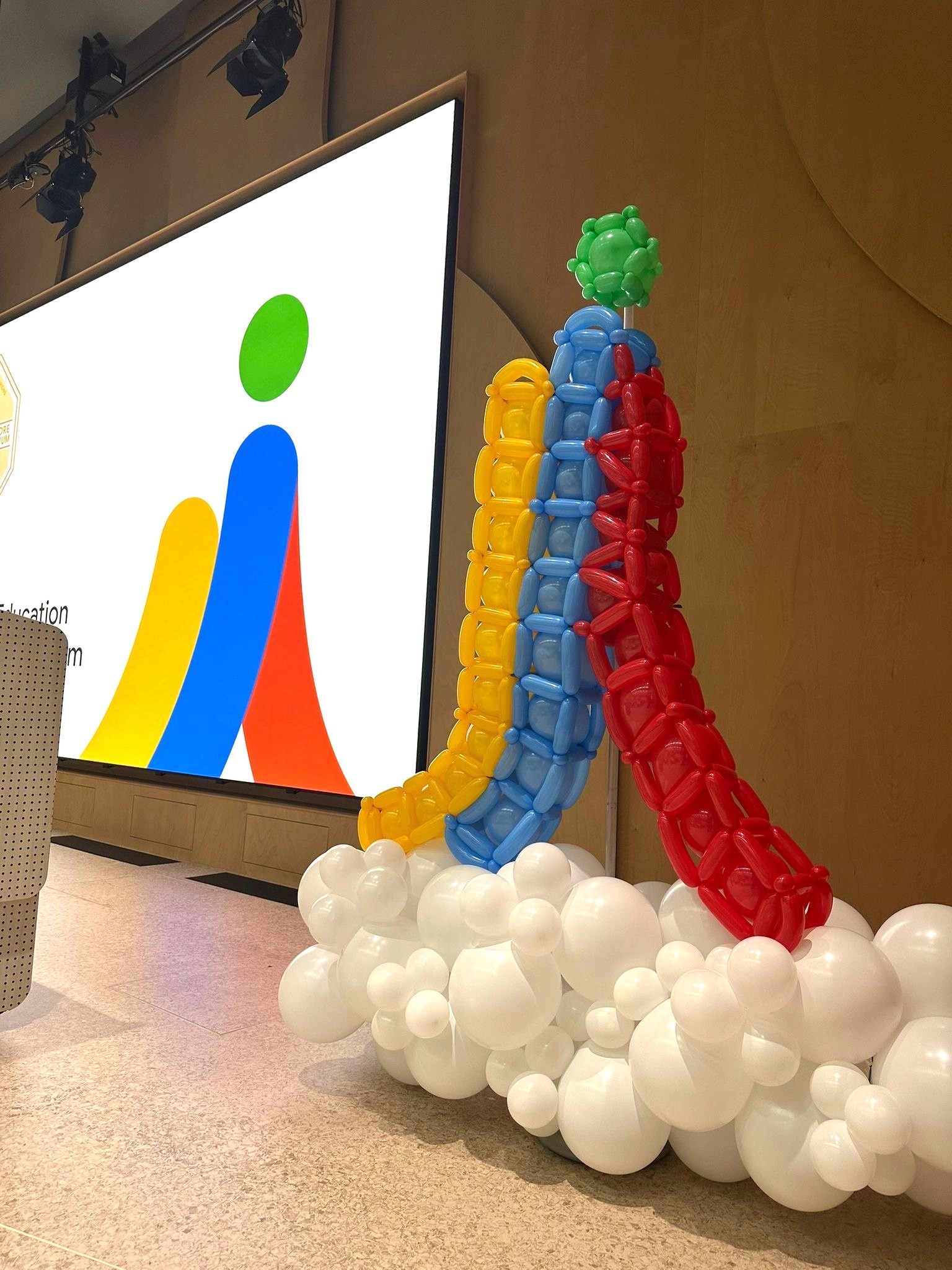 Custom branded balloon sculpture on a corporate event stage in Singapore