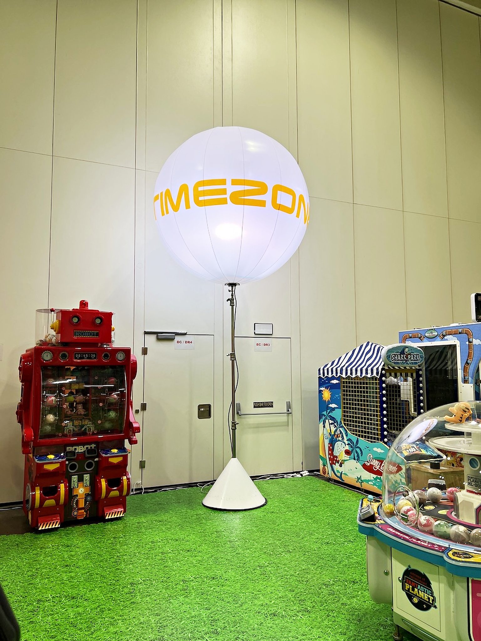 Timezone balloon stand beside an arcade display