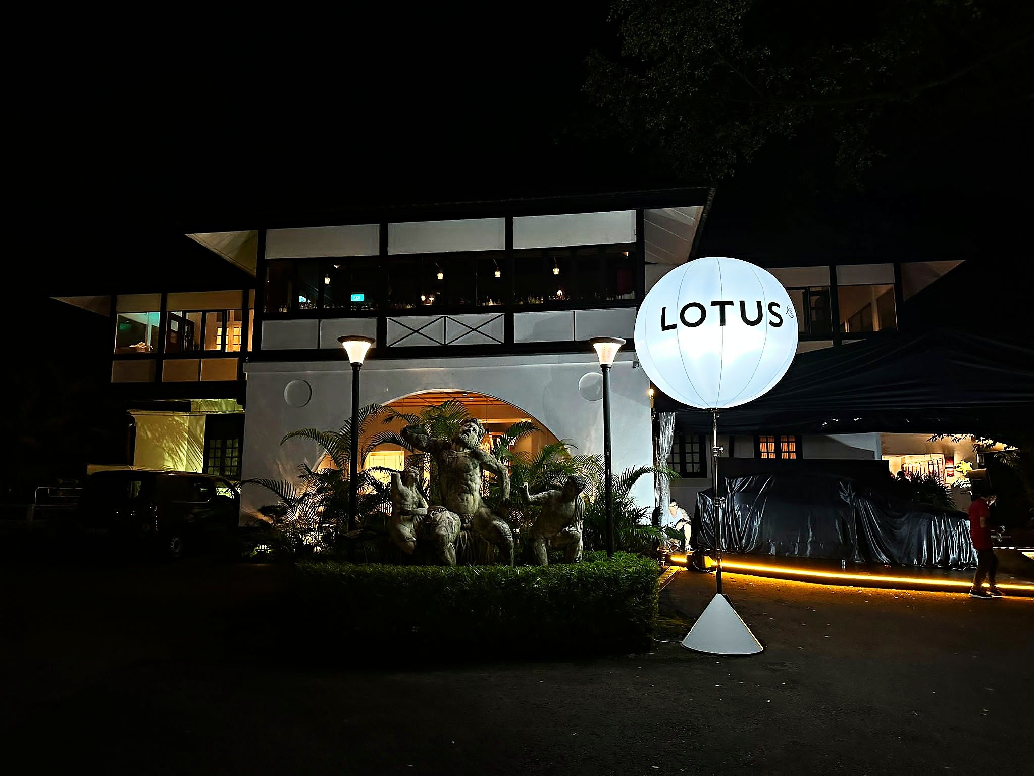 Illuminated Lotus balloon stand outside an evening venue