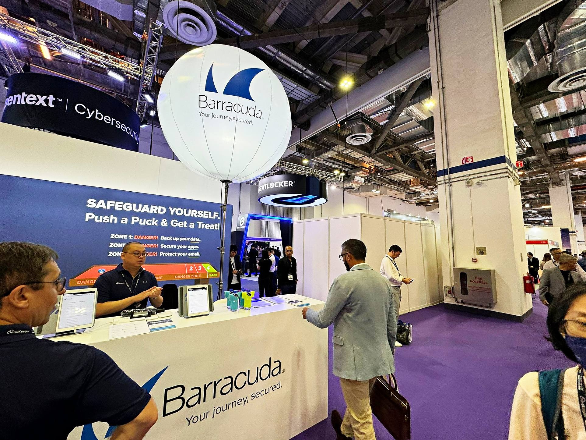Branded balloon stand above a Barracuda exhibition counter