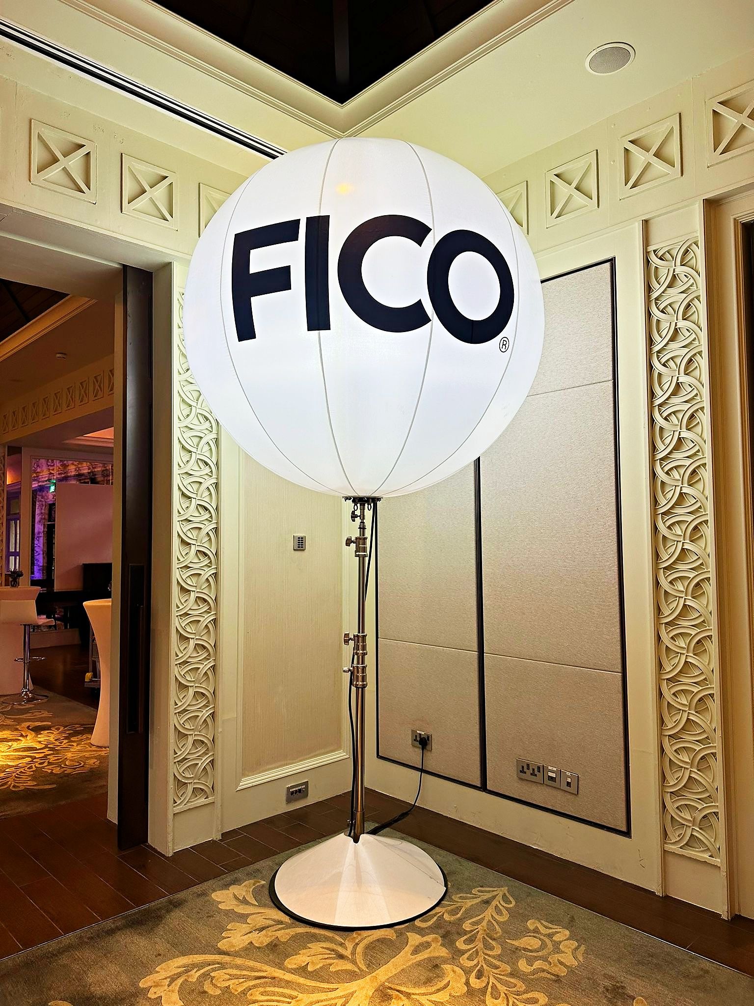FICO branded balloon stand beside a hotel doorway