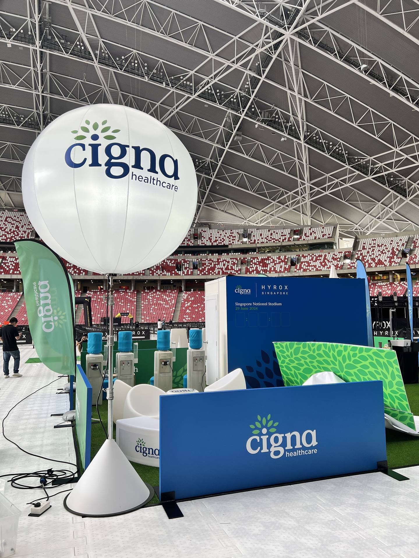 Cigna branded balloon stand at an indoor stadium booth