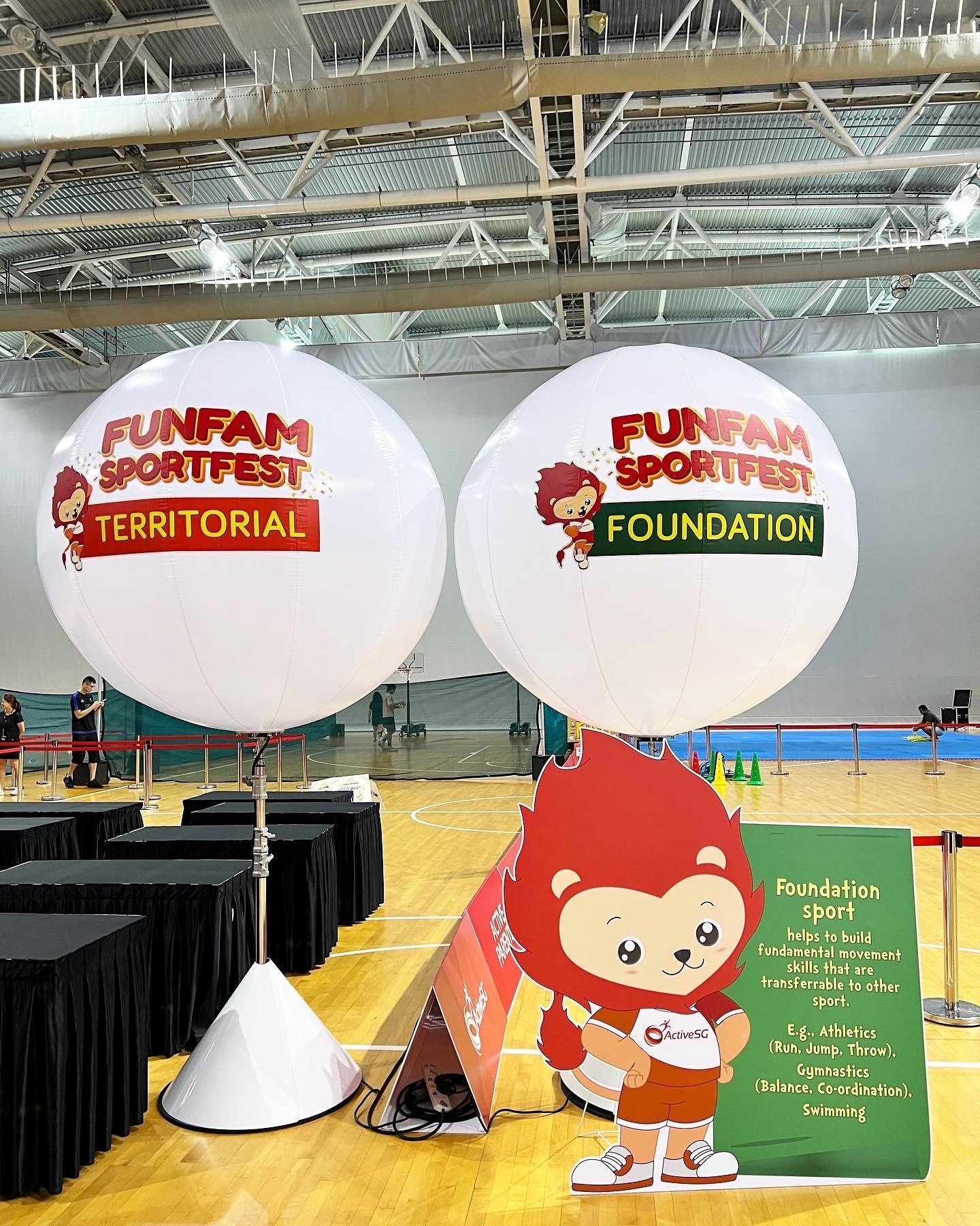Pair of lighted balloon stands identifying activity zones