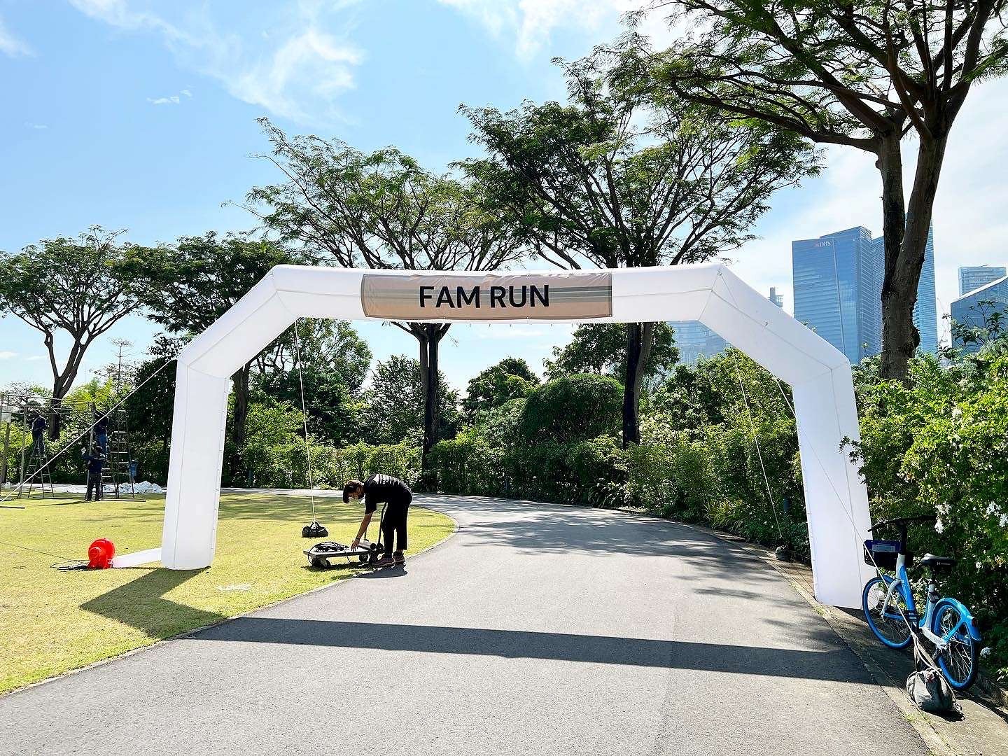 White FAM RUN inflatable arch along a park route