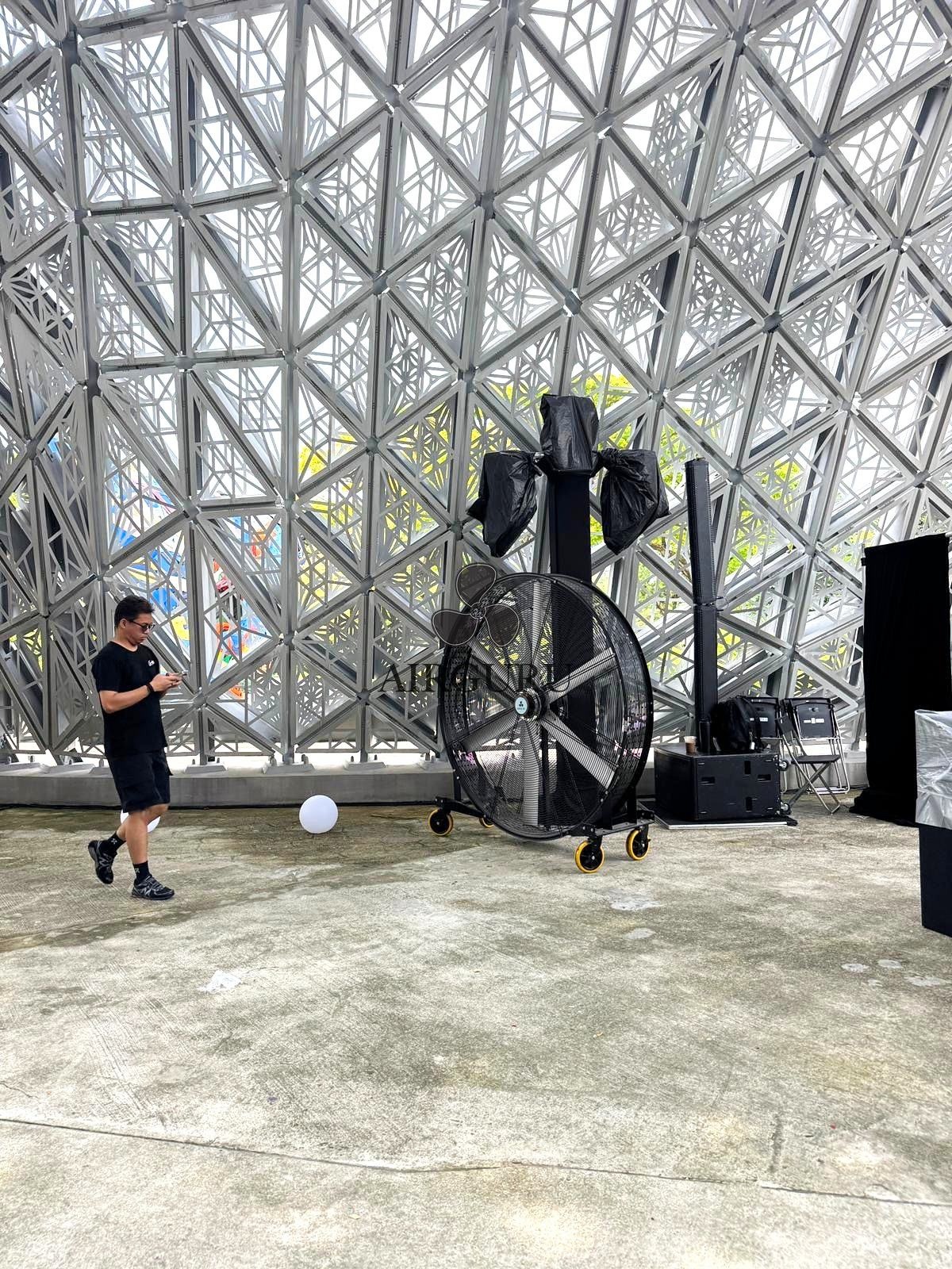 Airguru giant fan beside event production equipment in a pavilion