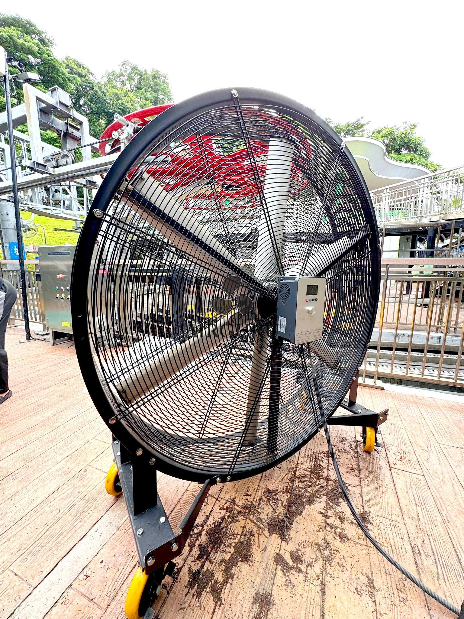 Airguru industrial fan on an outdoor wooden platform beside railings
