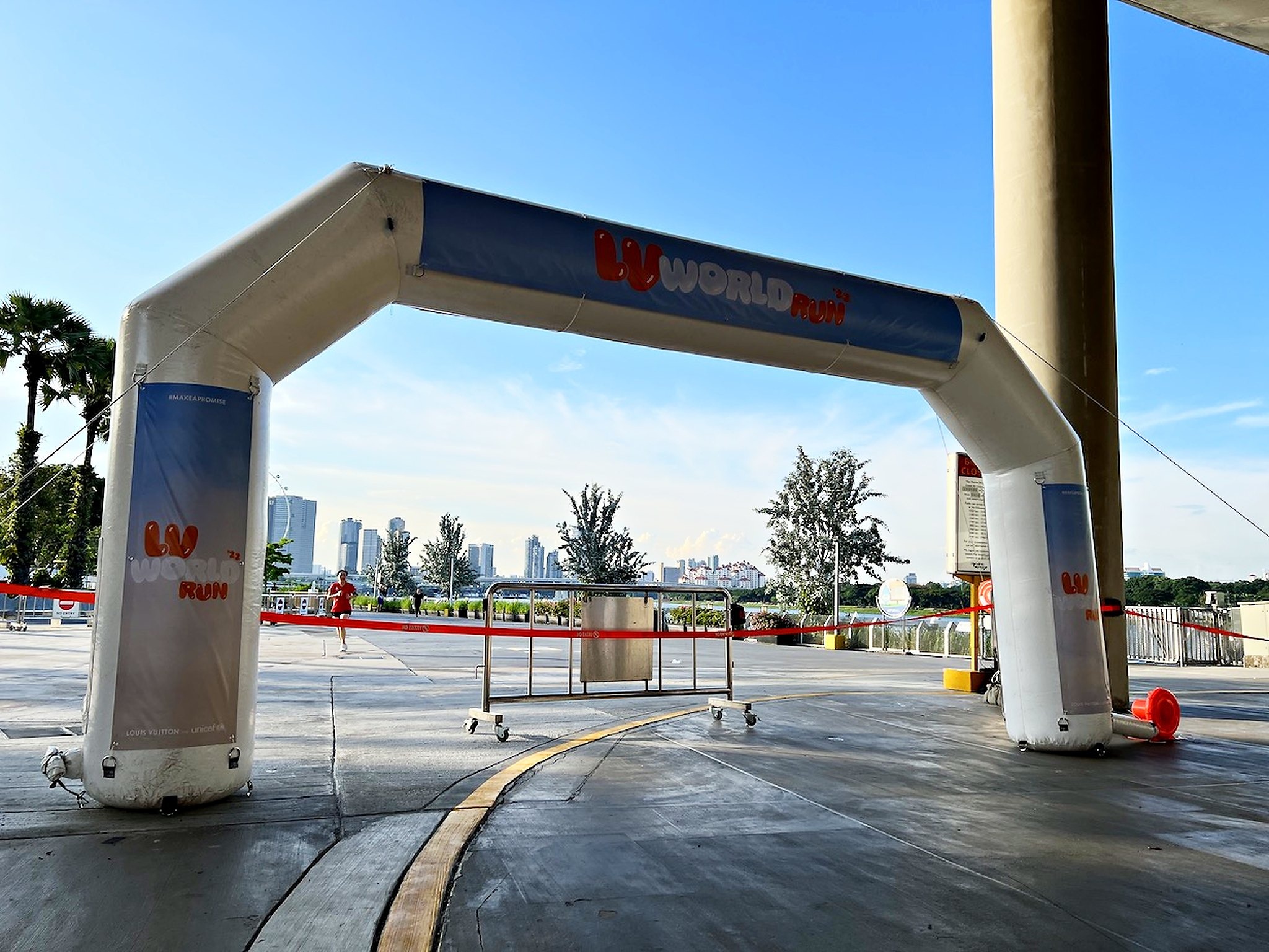 White marathon event arch positioned beside a sheltered access route