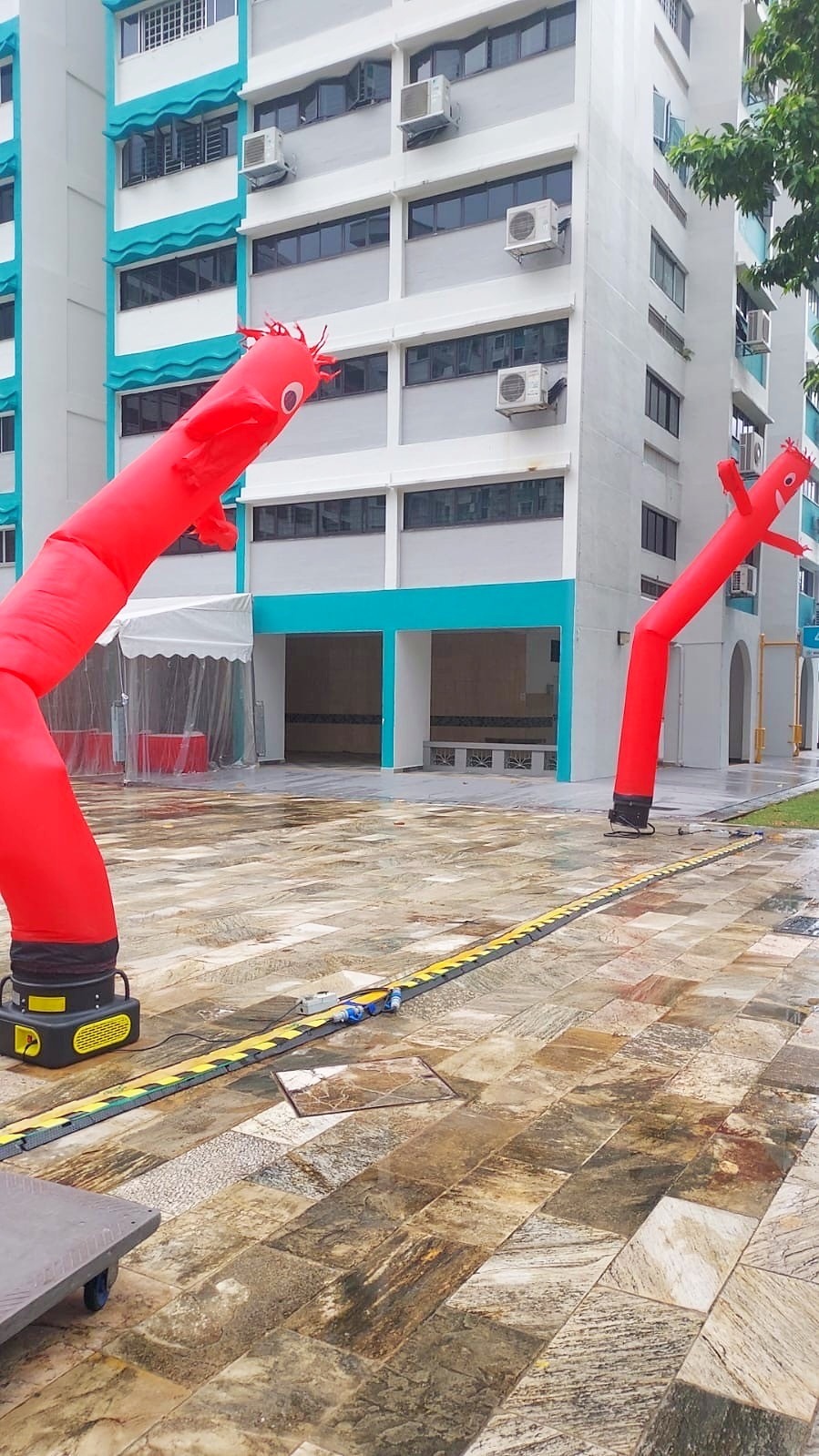 Red air dancers positioned around a courtyard