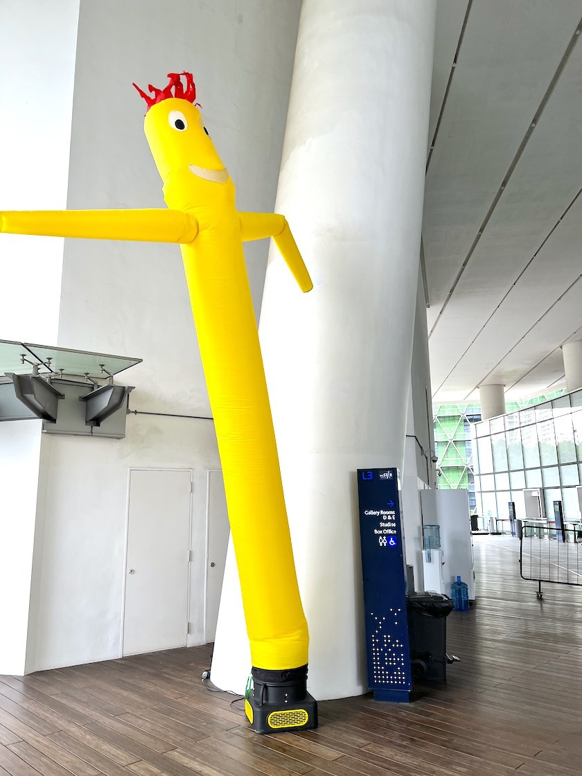 Yellow air puppet at a sheltered building entrance